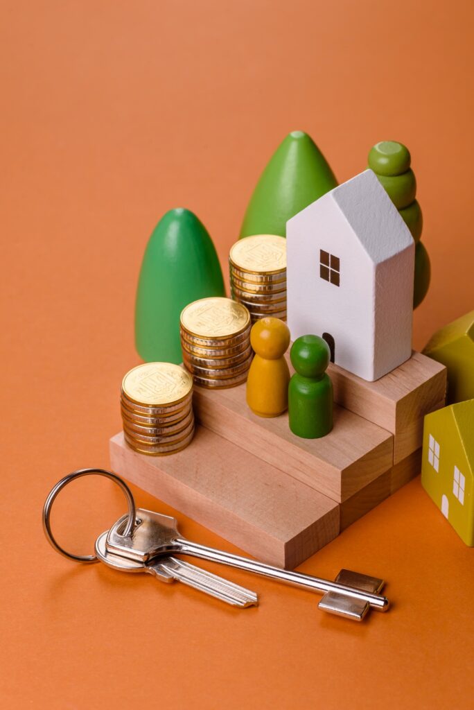 Conceptual composition of wooden steps with coins, model of a house